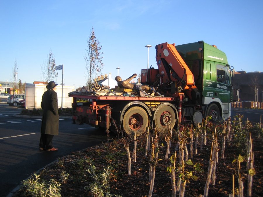 Hauling Man bronze sculpture on a delivery vehicle