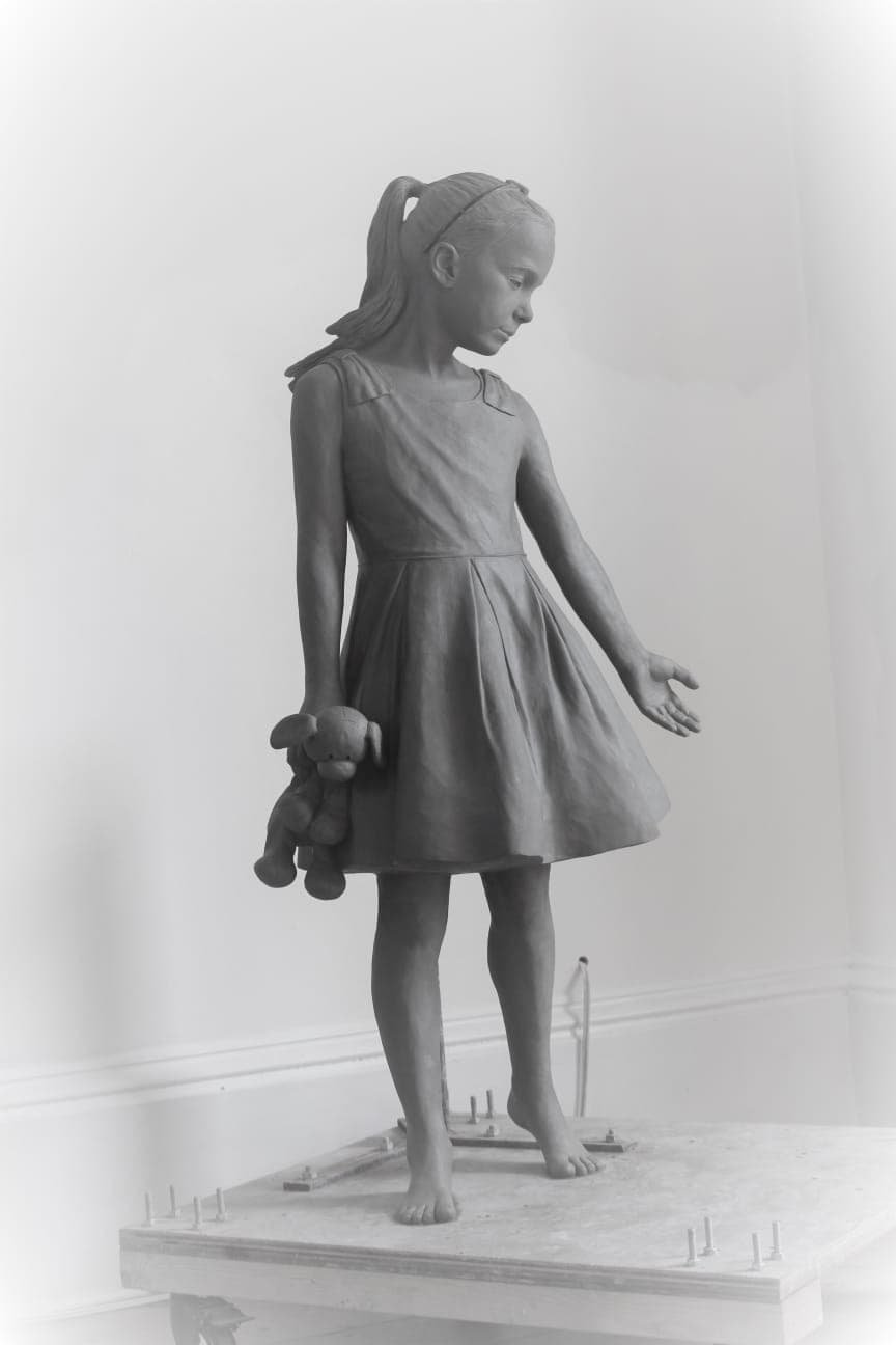 Life size clay sculpture of a young girl