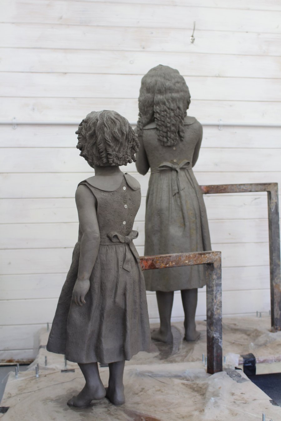 Two sisters clay sculpture