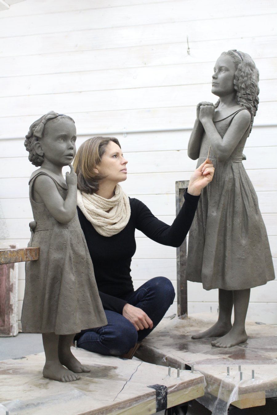 Hannah Stewart working on two sisters clay sculpture